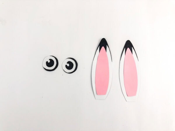 Finished paper eyes and assembled pink-and-white ears.
