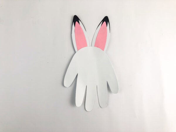 Paper handprint body with attached pink-and-white ears.
