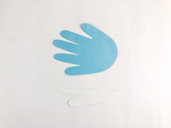 Blue handprint cutout and white fin cutout on a white background.