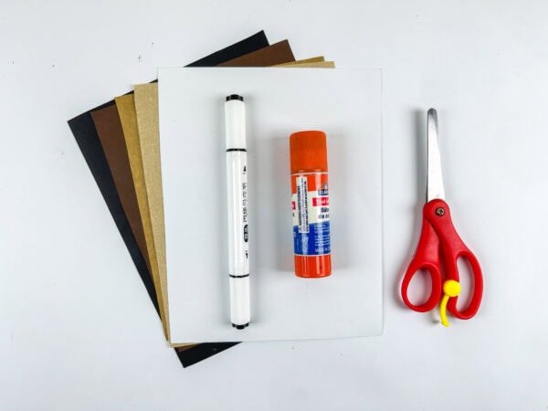 Craft supplies including paper, marker, glue stick, and scissors.