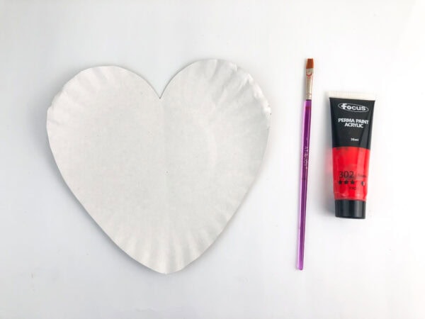 Heart-shaped paper plate with paint and brush ready to use.