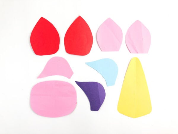 Cut paper pieces for unicorn ears, mane, snout, and horn.