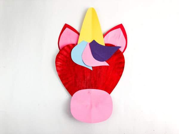 Unicorn paper plate craft with mane and snout pieces added.