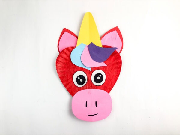 Finished unicorn paper plate craft with snout and smile.