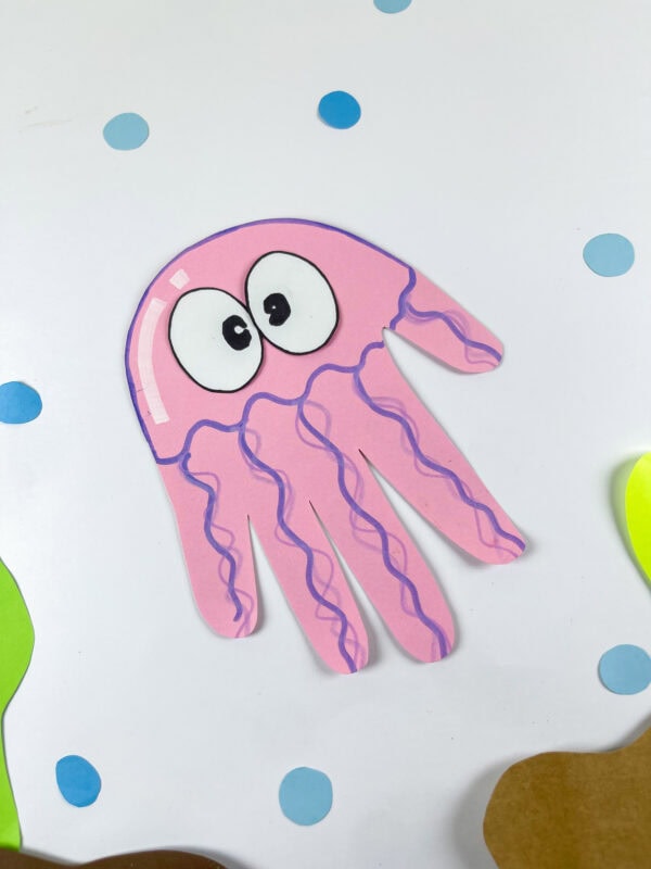 Close-up of pink jellyfish handprint paper craft with bubbles