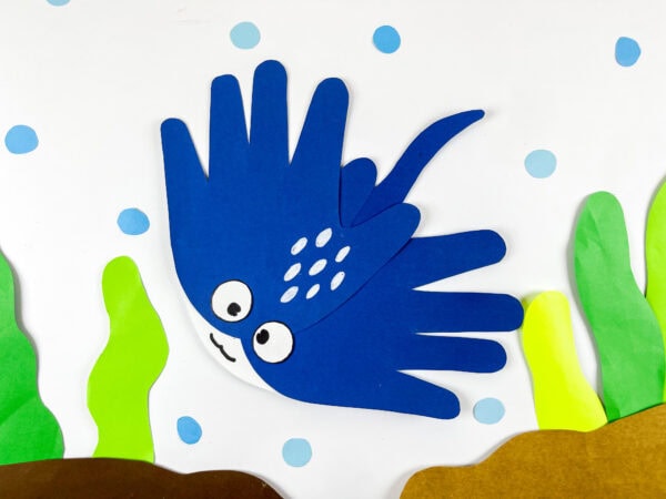 Blue stingray handprint craft with seaweed and bubbles