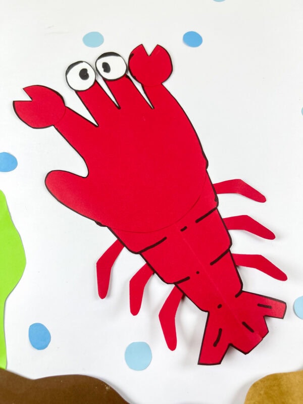 Finished lobster handprint paper craft on white background