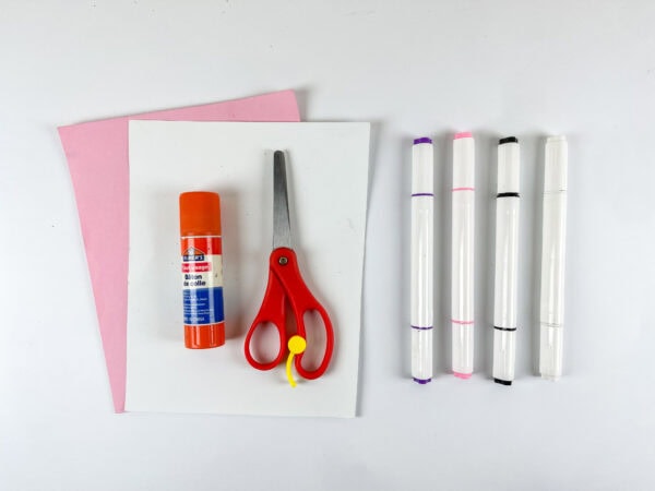 Craft supplies including paper, glue stick, scissors, and markers