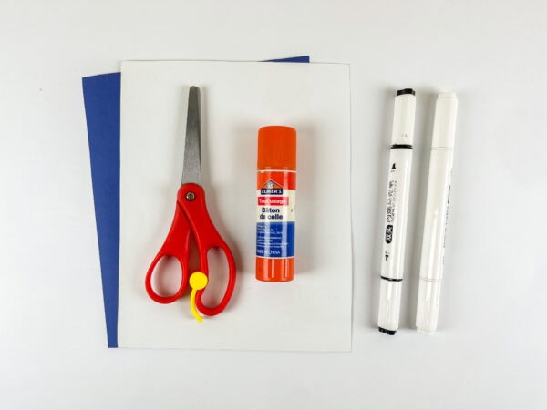 Craft supplies including paper, scissors, glue, and markers