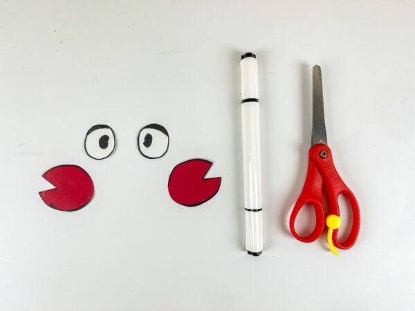 Paper lobster eyes and claws cut out with scissors
