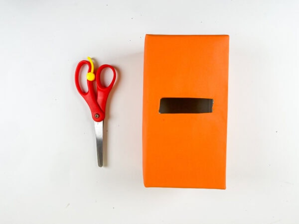 Orange wrapped box with card slot and scissors