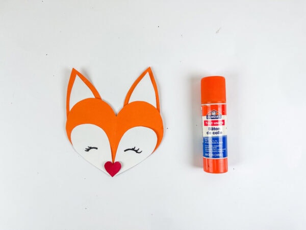 Fox face with glue stick on table