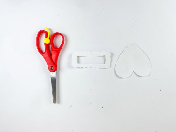 Scissors and paper pieces for box opening and heart