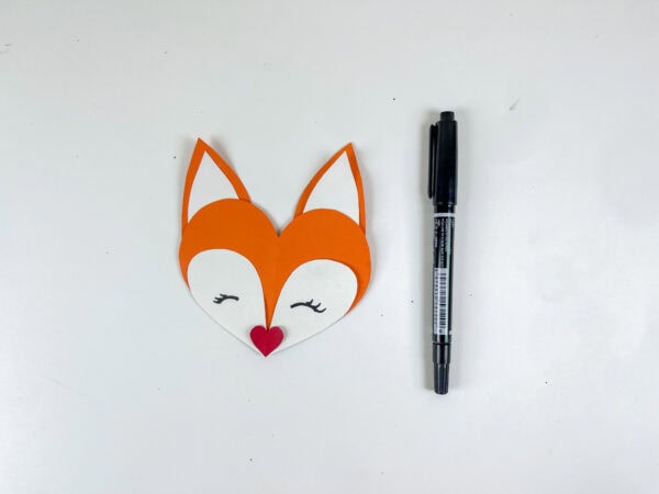 Assembled fox face with marker beside it