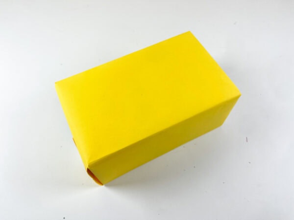 Box wrapped in yellow paper