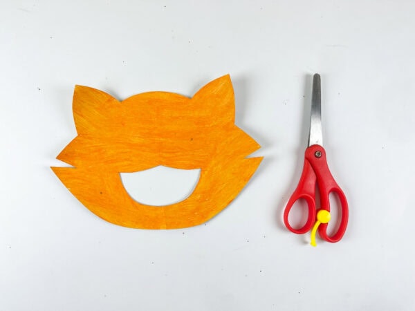 Cat face shape cut from orange paper