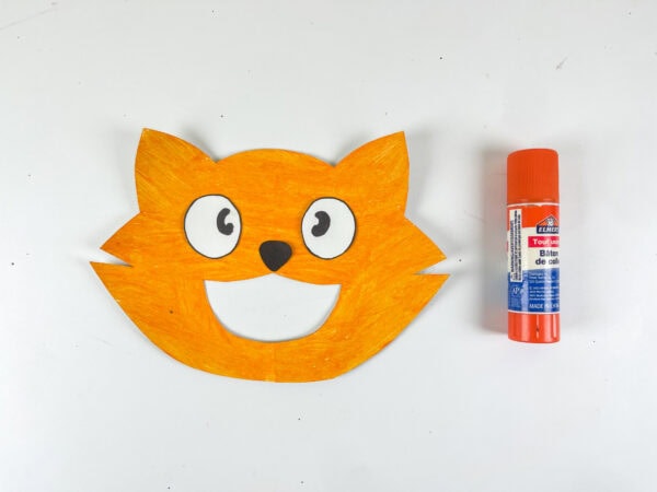 Completed cat face with glue stick beside it
