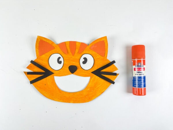 Cat face with whiskers attached and glue stick