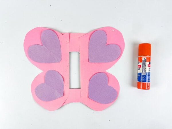Purple hearts glued onto pink butterfly wings