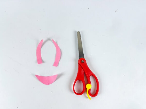Pink paper pieces for butterfly antenna and mouth with scissors