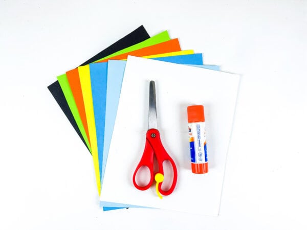 Colored paper sheets with scissors and glue