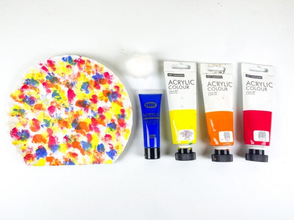 Painted paper plate with paint tubes