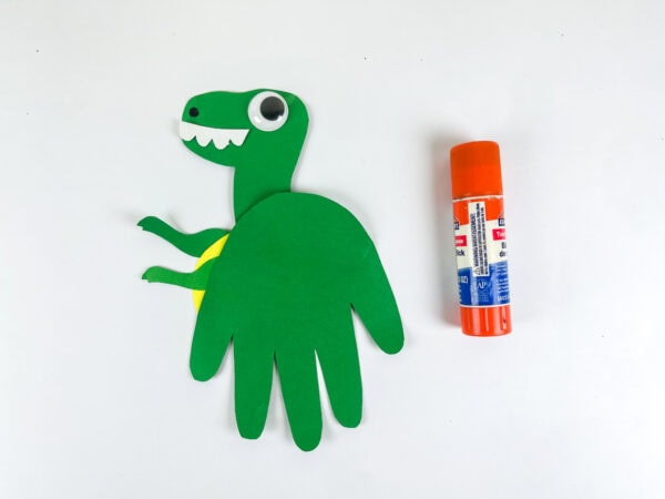 Tyrannosaurus handprint craft assembled with glue stick