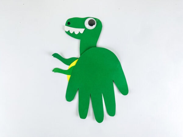 Completed Tyrannosaurus handprint craft on white background