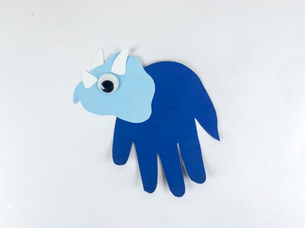 Completed triceratops handprint craft with attached eye and horns