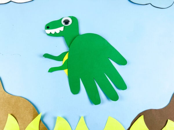Finished Tyrannosaurus handprint craft scene with grass