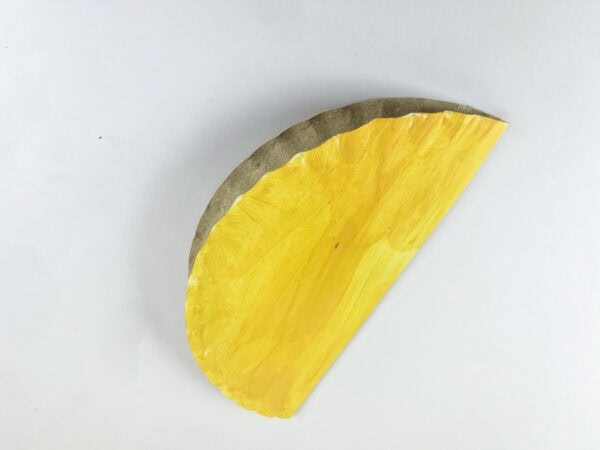 Folded yellow paper plate taco base