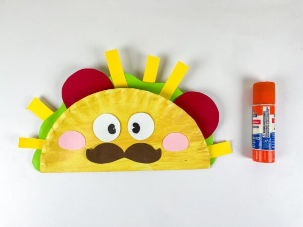 Completed taco paper plate craft with glue stick