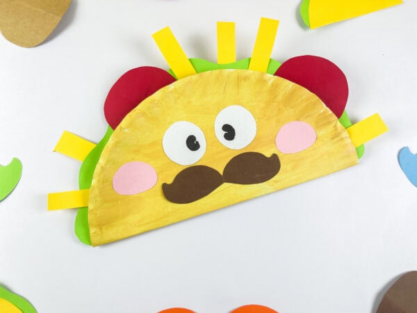 Cute taco paper plate craft on table