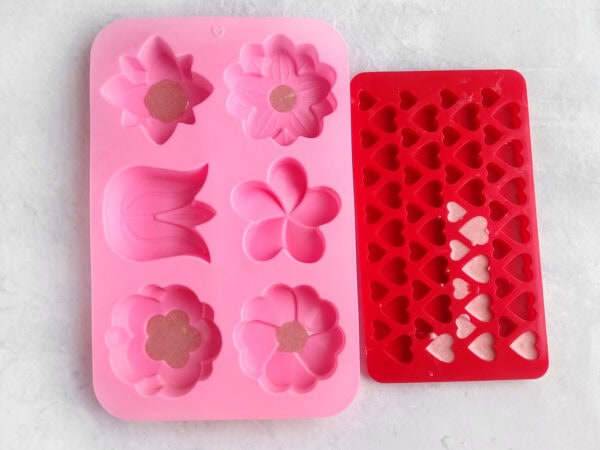 Pink flower mold tray and red heart-shaped silicone mold