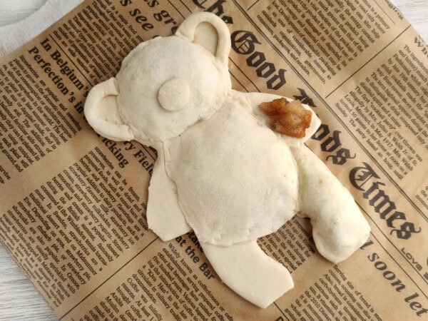 Dough sealed into teddy bear pastry shape
