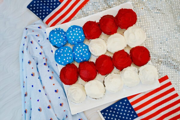 American flag cupcakes on tray with festive background