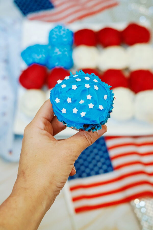 Blue frosted cupcake with white star sprinkles