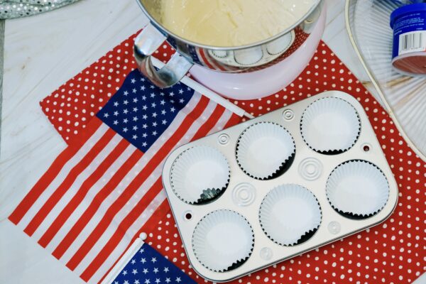 Cupcake liners in pan with mixer batter nearby