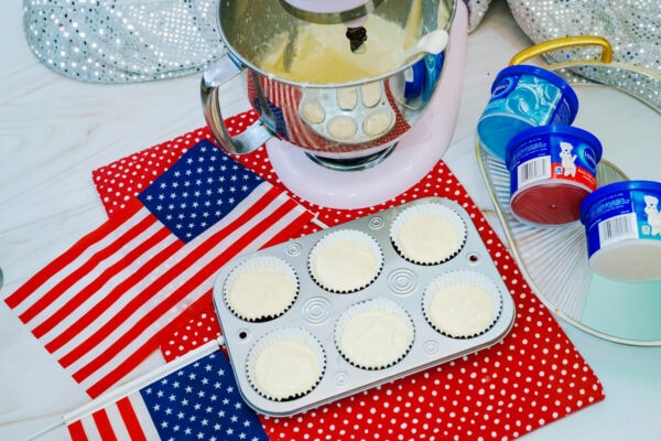 Cupcake batter poured into lined cupcake tray