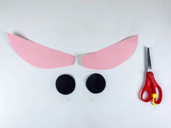 Pink ear shapes and black eye circles cut out