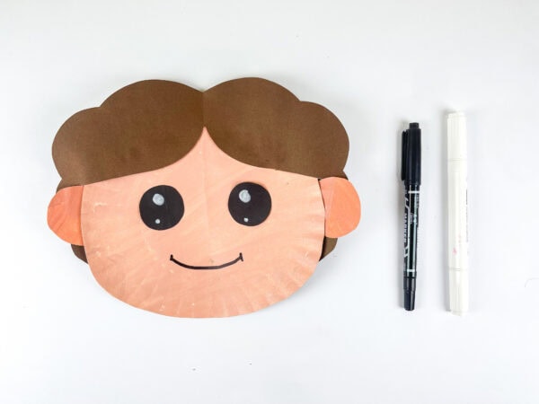 Eyes and smile drawn on Han Solo paper plate face