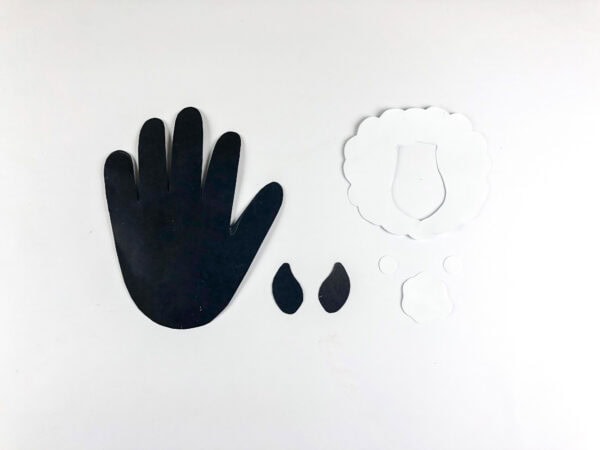 Cut paper handprint and goat template pieces