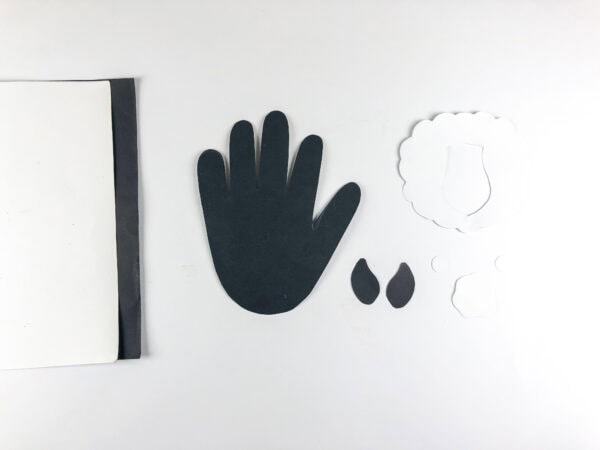 Cut paper handprint and goat template pieces