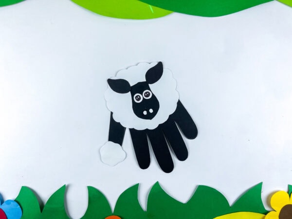 Goat handprint craft on grass paper background