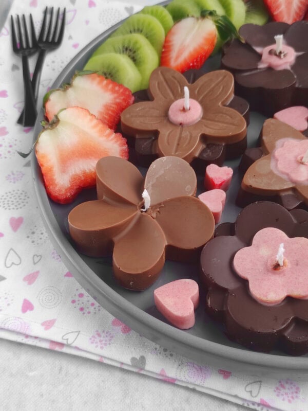 Close-up chocolate flower candles with strawberries and heart candies