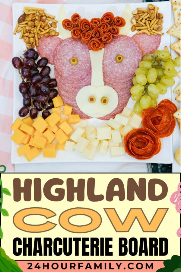 Highland cow charcuterie board with grapes, cheese, crackers, and salami