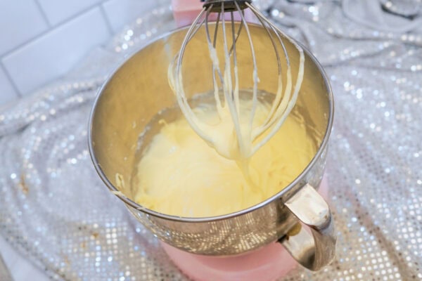 Cupcake batter being mixed in stand mixer bowl