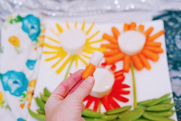 Hand holding carrot and ranch dip snack