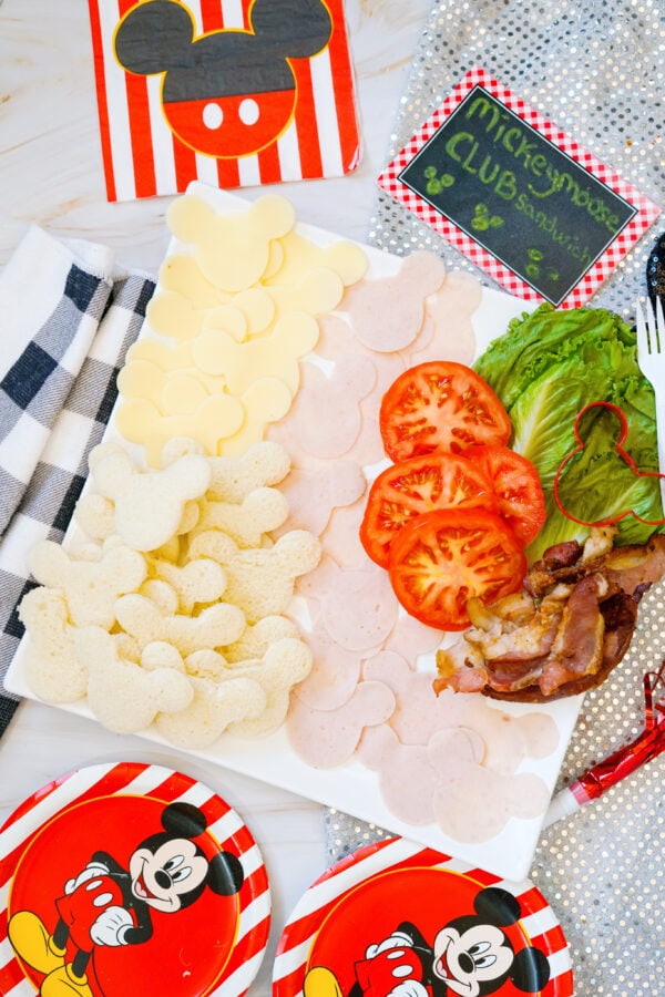 Overhead view of Mickey sandwich board with themed party plates