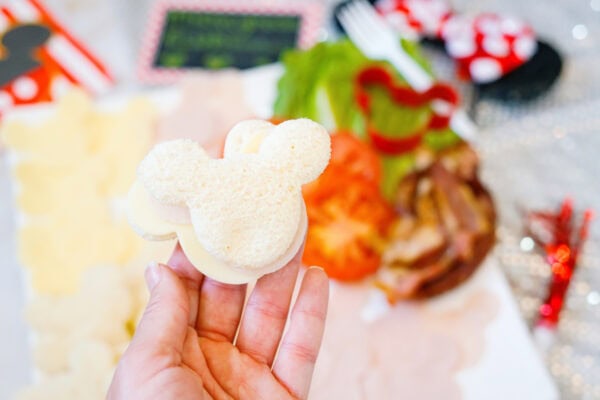 Hand holding Mickey-shaped sandwich bread close up

